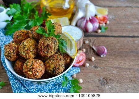 Falafel - deep fried balls of ground chickpeas with tahini sauce from
