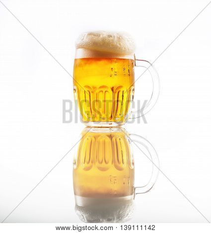 Full glass of beer with foam .