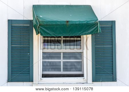 sash window with hunter green simple awing tent and shutters