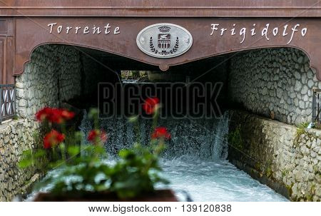 Frigidolfo River Flows Inside Ponte Di Legno Under A Bridge
