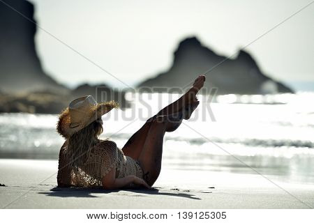 young woman relaxing on the beach in summer day