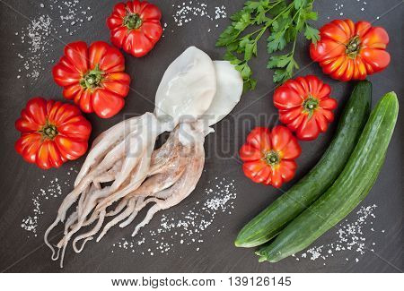 Healthy raw food for diet: cuttlefish heirloom tomatoes and cucumbers. Flat lay photography.