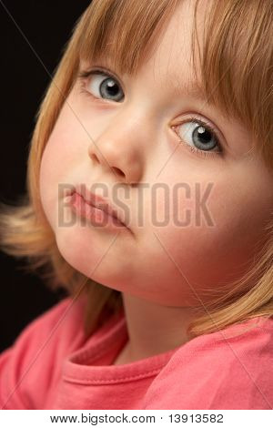 Close Up Studio Portrait Of Sad Young Girl