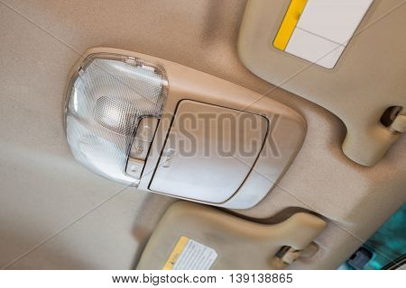 Sunglasses box/case or storage box and light button switch in car interior detail