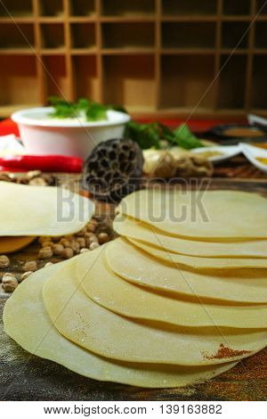 Colorful Indian food - papadum chickpea gram flour and spices on textured wooden table top