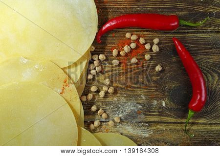 Colorful Indian food - papadum chickpea gram flour and spices on textured wooden table top
