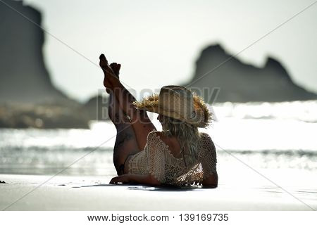 young woman relaxing on the beach in summer day