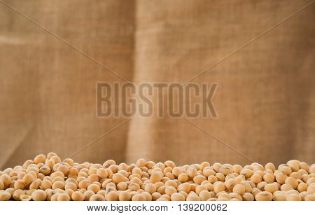Soybeans with sackclote background.Selective focus on front soybeans.