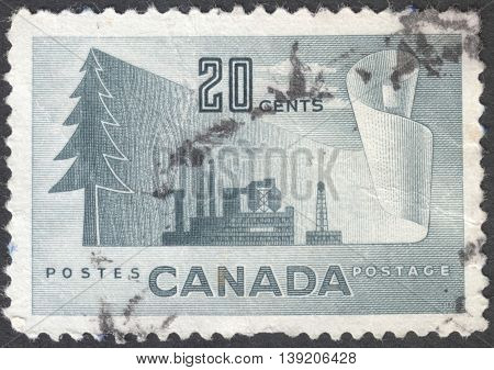 MOSCOW RUSSIA - CIRCA JANUARY 2016: a post stamp printed in CANADA shows image of a tree and an industrial plant the series 