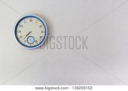 The clock mounted on the wall of wallpaper
