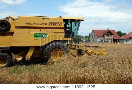 TRNOVEC, CROATIA - JULY 09, 2016: Combine harvester harvest ripe wheat on a farm in Trnovec, Croatia on July 09, 2016