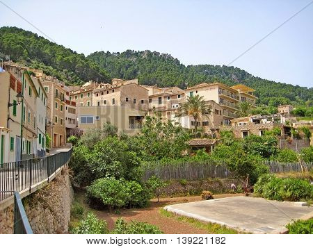 Banyalbufar Spain - June 23 2008: View over the village in the north of Majorca. Houses and hotels square in front.