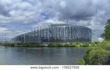 STRASBOURG, FRANCE - JUNE 19, 2016: back of European Parliament, Louise Weiss building, 1999 in Wacken district of Strasbourg and Ill river