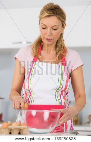 cook breaking egg and cooking tasty pie
