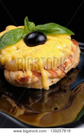 pieces of chicken brisket a slice of pineapple with cheese olives and basil