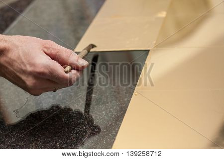 Master works with a thin gold leaf pieces on glass hands in the center of the frame