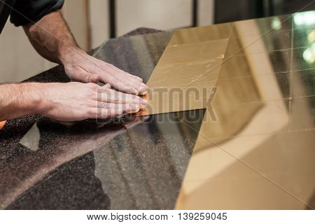Master works with a thin gold leaf pieces on glass hands in the center of the frame