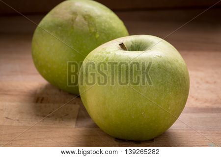 Green Granny Smith Apples on a Wood Cutting Board