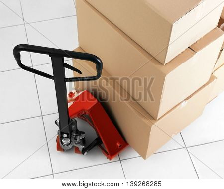 Manual pallet truck with carton boxes indoors