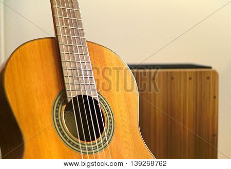 Cajon in background and guitar in foreground