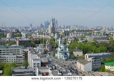 Temple of St. Sergius of Radonezh, Stalin skyscraper and office skyscrapers at sunny day in Moscow