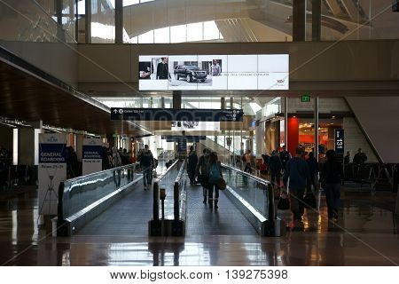 LOS ANGELES, UNITED STATES - DECEMBER 28: Travelers go on and next off the flat escalator of a departure terminal at LAX on December 28 2015 Los Angeles.