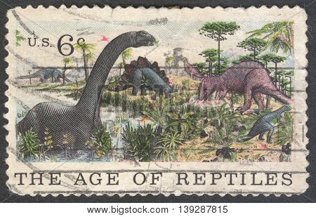 MOSCOW RUSSIA - JANUARY 2016: a stamp printed in the USA shows Apatosaurus Stegosaurus & Allosaurus the series "The 100th Anniversary of the American Museum of Natural History New York circa 1969