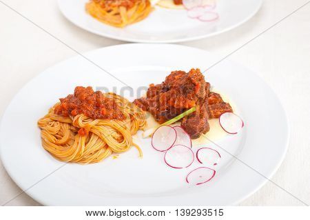 Pasta With Pork Ribbs Sauce On Polenta Bed