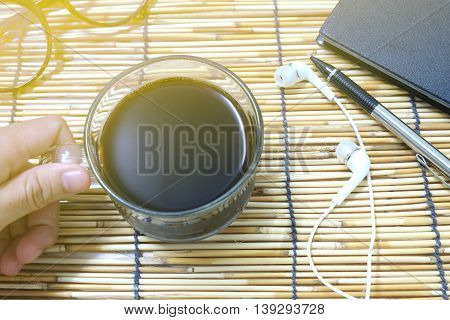 Hands holding a black coffee cup .