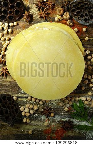 Colorful Indian food - papadum chickpea gram flour and spices on textured wooden table top