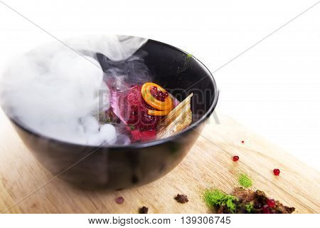 Molecular Cuisine. Delicious modern soup with beetroot. Isolated on white. Stock image.