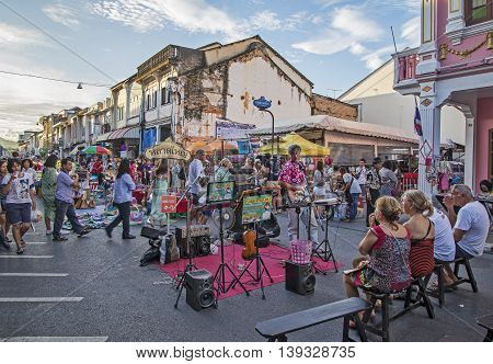 PHUKET THAILAND NOVEMBER 01 2015: Tourists shop at the old town night market (walking street) among old building Chino Portuguese style street of Phuket town in Phuket Thailand.