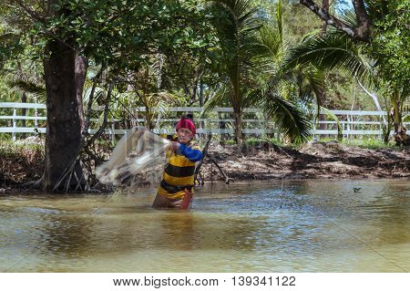 Tuaran, Sabah, Malaysia - June 7, 2016: Unidentified fisherman catch fish by throwing net.