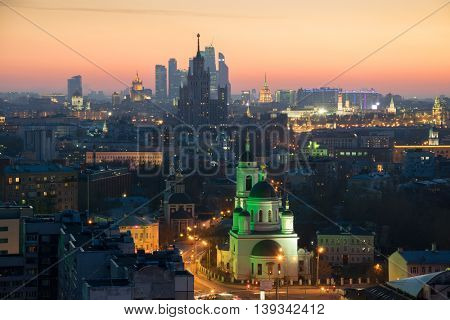 Panorama, Temple of St. Sergius of Radonezh, Stalin skyscraper and office skyscrapers at sunset in Moscow