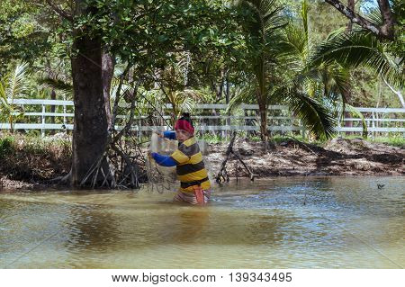 Tuaran, Sabah, Malaysia - June 7, 2016: Unidentified fisherman catch fish by throwing net.