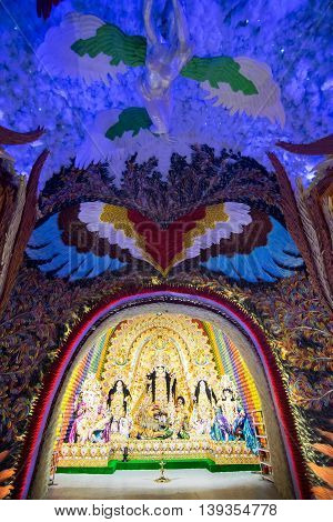 KOLKATA INDIA - OCTOBER 18 2015 : Night image of decorated Durga Puja pandal shot at colored light at Kolkata West Bengal India. Durga Puja is biggest religious festival of Hinduism.