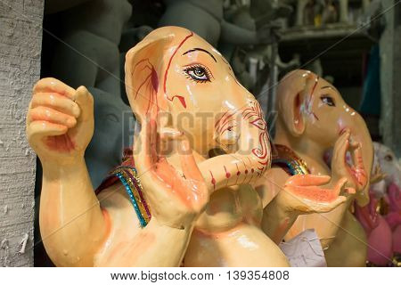 KOLKATA WEST BENGAL INDIA - 13 SEPTEMBER 2015: Beautiful fresh painted clay idol of Lord Ganesha at Kumartuli as preparation for 