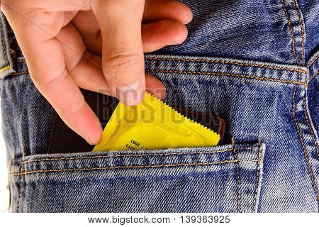 Condoms and billfold, in jeans pocket.Concept Sexually transmitted infections STIs