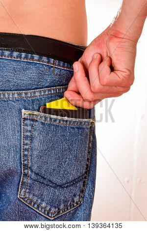 Condoms and billfold, in jeans pocket.Concept Sexually transmitted infections STIs