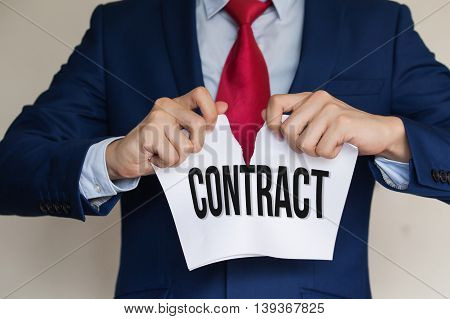 Businessman Tearing Contract Apart On White Background