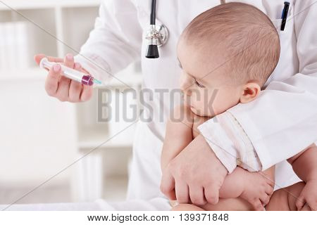 Doctor Doing Vaccine Injection To Baby Boy