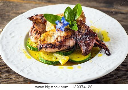 Grilled Squid With Lemon And Zucchini On Wooden Background