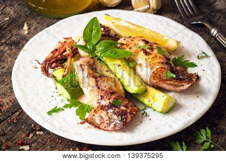 Grilled Squid With Lemon And Zucchini On Wooden Background