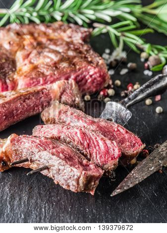 Medium Ribeye steak with spices on the graphite tray.