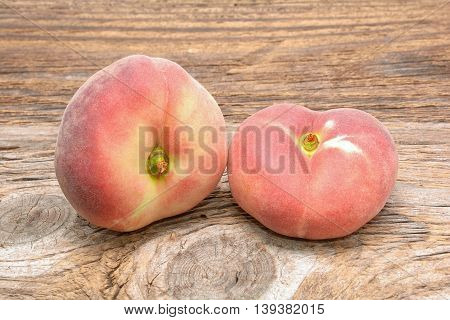 donut peaches isolated on wooden background in studio