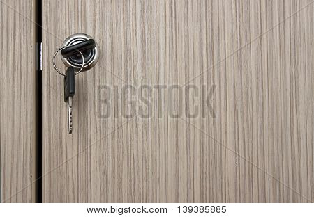 Key in lock on a wooden locker in an office