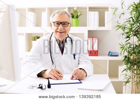 Specialist otologist doctor smiling and posing in office