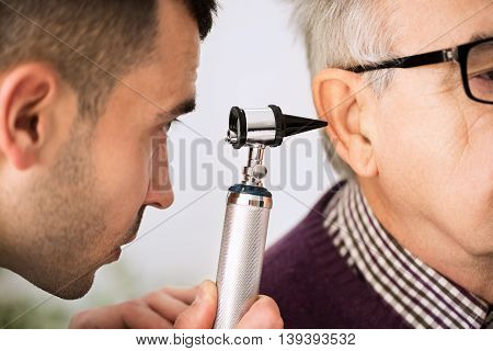 Doctor Examining Ear Of A Patient