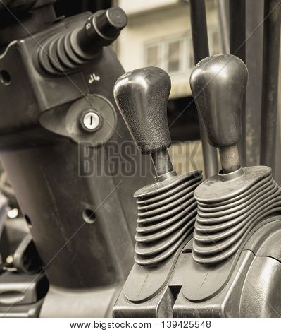 Old and dirty forklift operating levers control selective focus