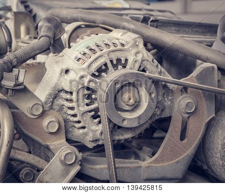 Old alternator for the car attached on engine vintage effect